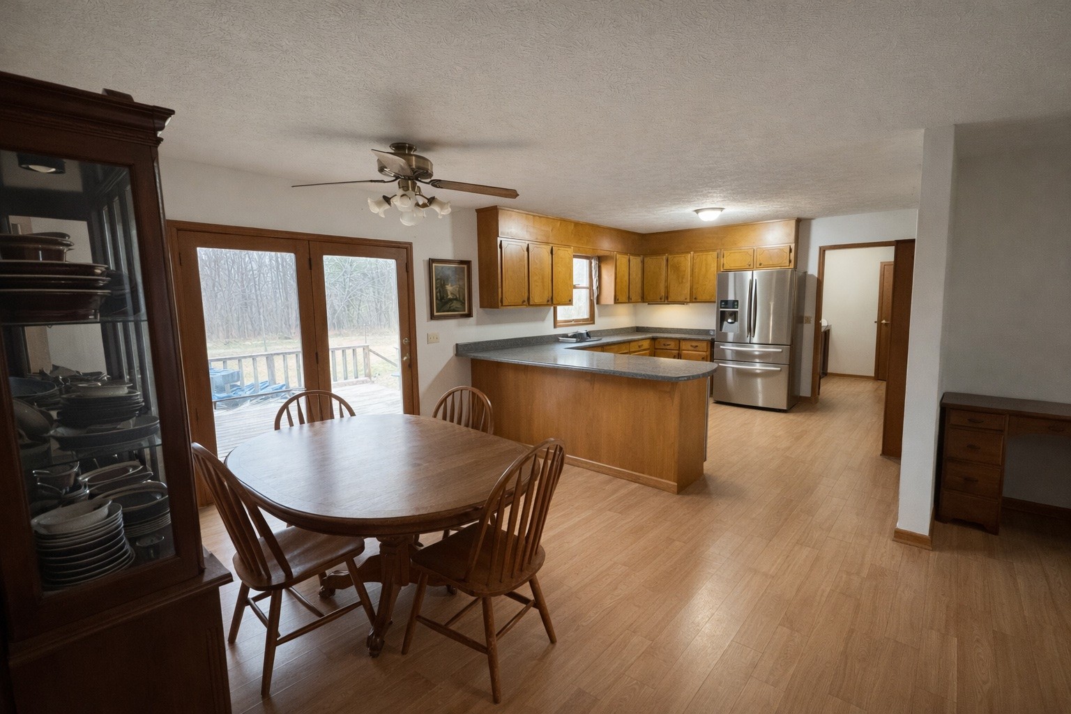 2813 She Boss Road Duck River, TN 38454 - Photo 14 of 21 a kitchen with kitchen island granite countertop a stove a refrigerator a sink a dining table and chairs with wooden floor