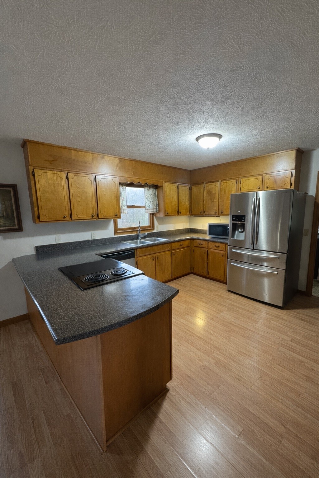 2813 She Boss Road Duck River, TN 38454 - Photo 7 of 21 a kitchen with stainless steel appliances granite countertop a sink a stove and a refrigerator