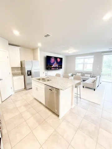 a large white kitchen with cabinets