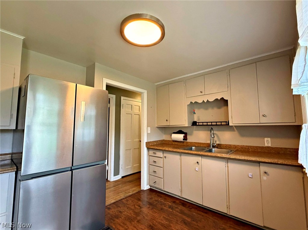 210 Callahan Road Canfield, OH 44406 - Photo 16 of 34 Updated kitchen with cream cabinetry, wood-finish countertops, stainless steel appliances including refrigerator and sink, hardwood flooring, and recessed ceiling lighting
