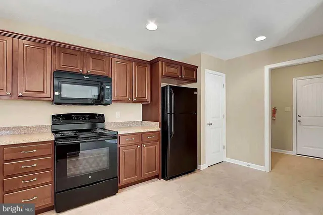 a kitchen with stainless steel appliances granite countertop a stove microwave and refrigerator
