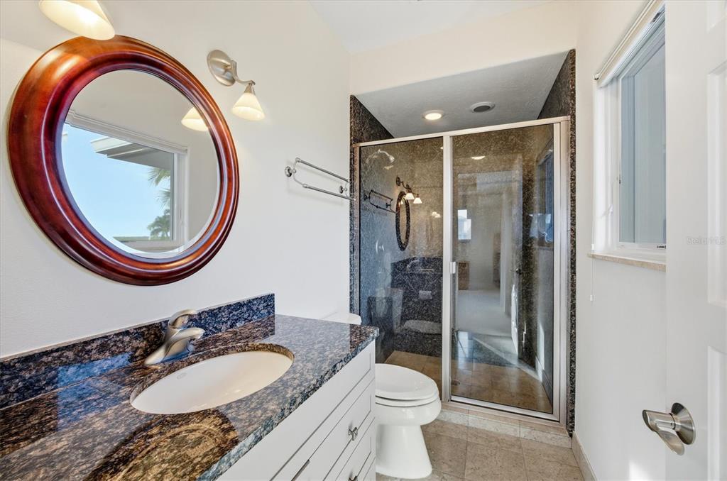 761 Norton Street Longboat Key, FL 34228 - Photo 48 of 66 a bathroom with a granite countertop sink mirror vanity and toilet