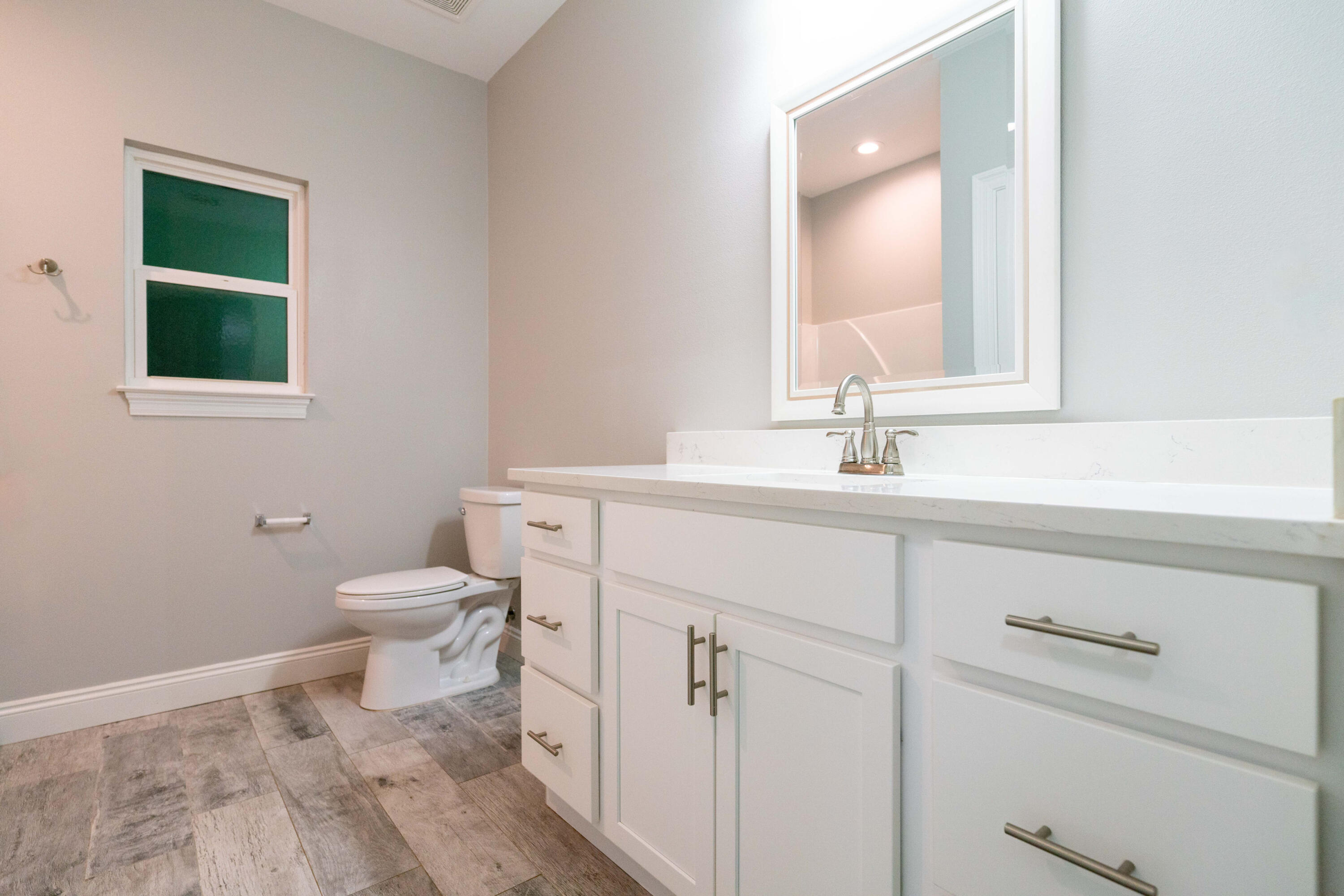 2243 Wind Trace Road North Navarre, FL 32566 - Photo 21 of 34 a bathroom with a sink toilet and mirror