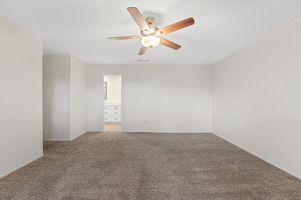 4007 Ridgebrook Drive Arlington, TX 76015 - Photo 13 of 18 Spacious room featuring neutral carpeting and light-toned walls