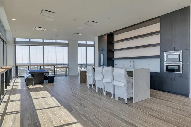 a living room with furniture wooden floor and a table
