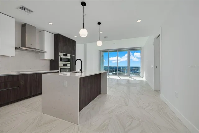 a kitchen with granite countertop a stove and a sink