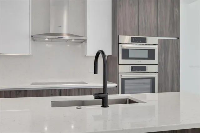 a kitchen with a refrigerator and a sink