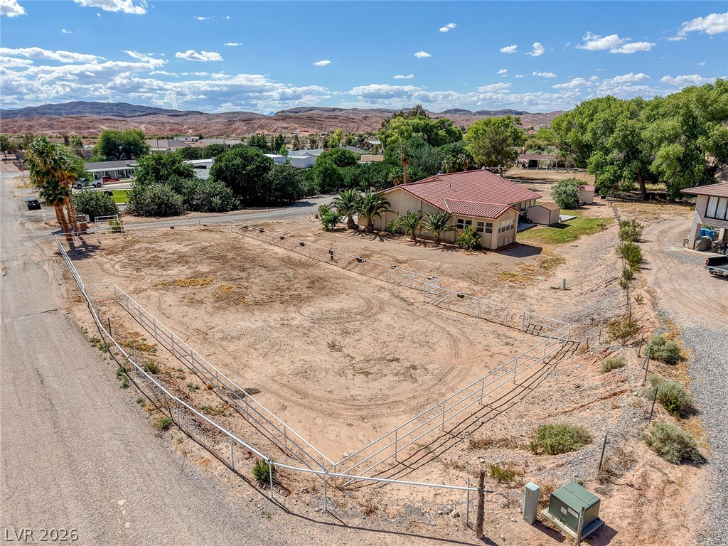1950 Bowman Road Logandale, NV 89021 - Photo 18 of 98 Vast desert lot with fencing ready for your vision, featuring a backdrop of distant hills.