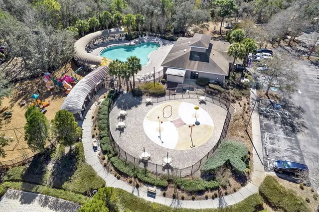an aerial view of a house with a swimming pool and outdoor seating