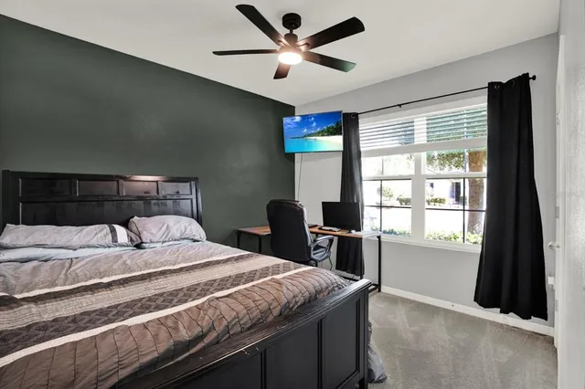 a bedroom with a large bed and a window