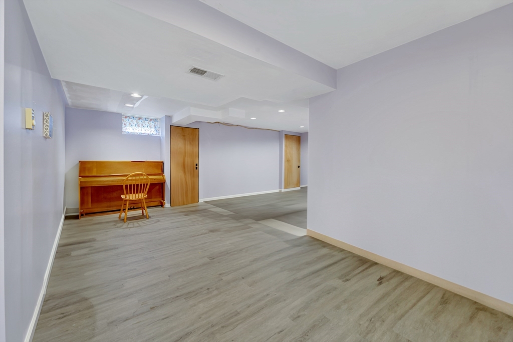4 Rebecca Road Newton, MA 02465 - Photo 29 of 39 a view of an empty room with wooden floor and a window