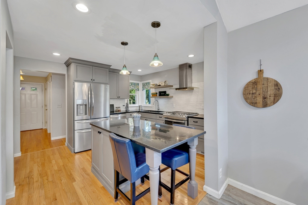 4 Rebecca Road Newton, MA 02465 - Photo 5 of 39 a kitchen with stainless steel appliances granite countertop a sink and a refrigerator