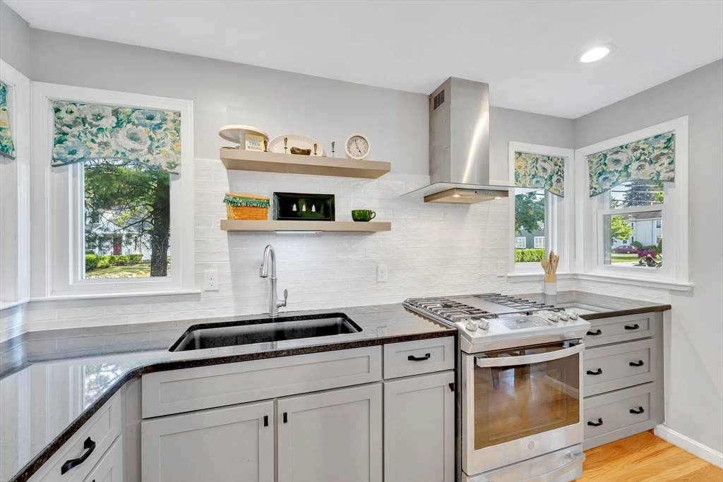 4 Rebecca Road Newton, MA 02465 - Photo 7 of 39 a kitchen with stainless steel appliances granite countertop a sink stove and cabinets