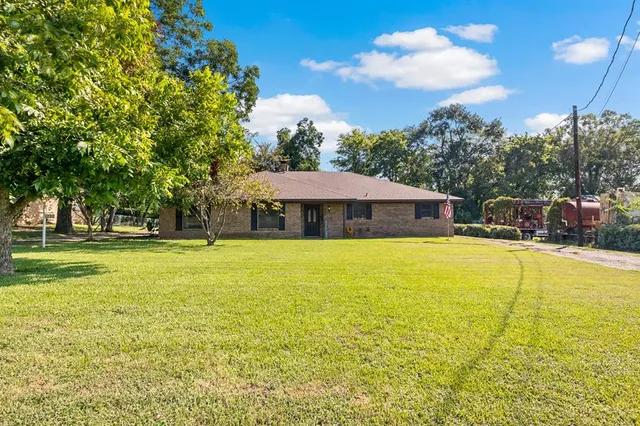 a house view with swimming pool in front of it