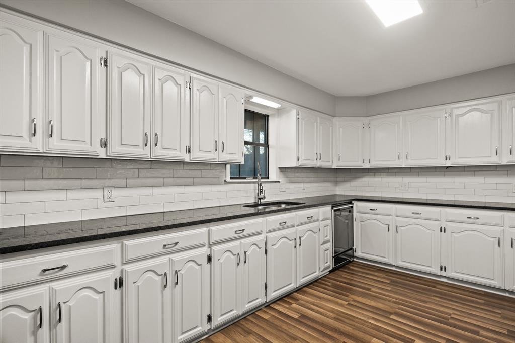 231 Quitman Street Pittsburg, TX 75686 - Photo 12 of 32 a kitchen with white cabinets
