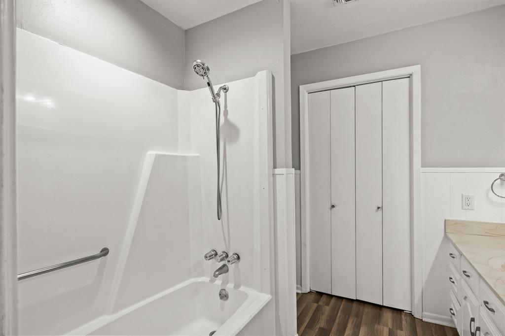 231 Quitman Street Pittsburg, TX 75686 - Photo 19 of 32 a bathroom with a bathtub a sink and a shower