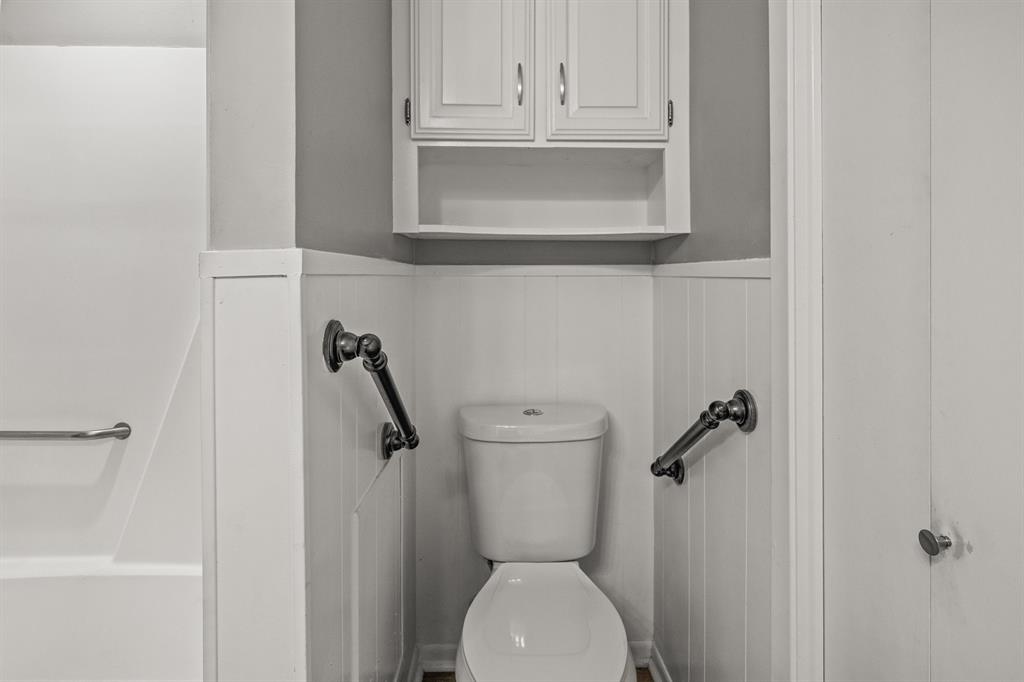 231 Quitman Street Pittsburg, TX 75686 - Photo 20 of 32 a bathroom with a toilet and a sink