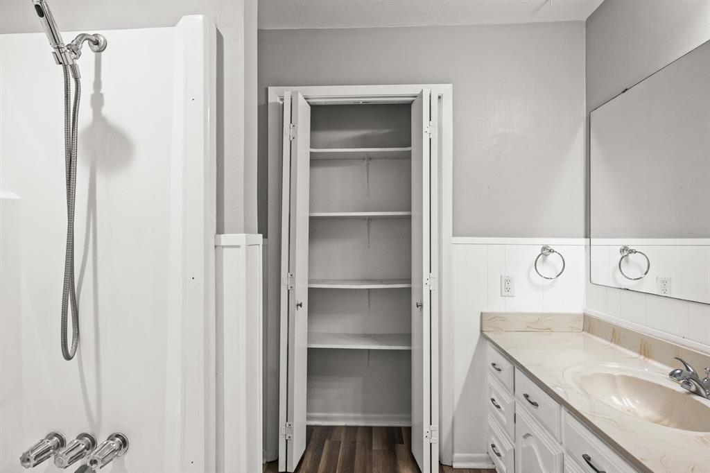 231 Quitman Street Pittsburg, TX 75686 - Photo 21 of 32 a bathroom with a sink and a mirror