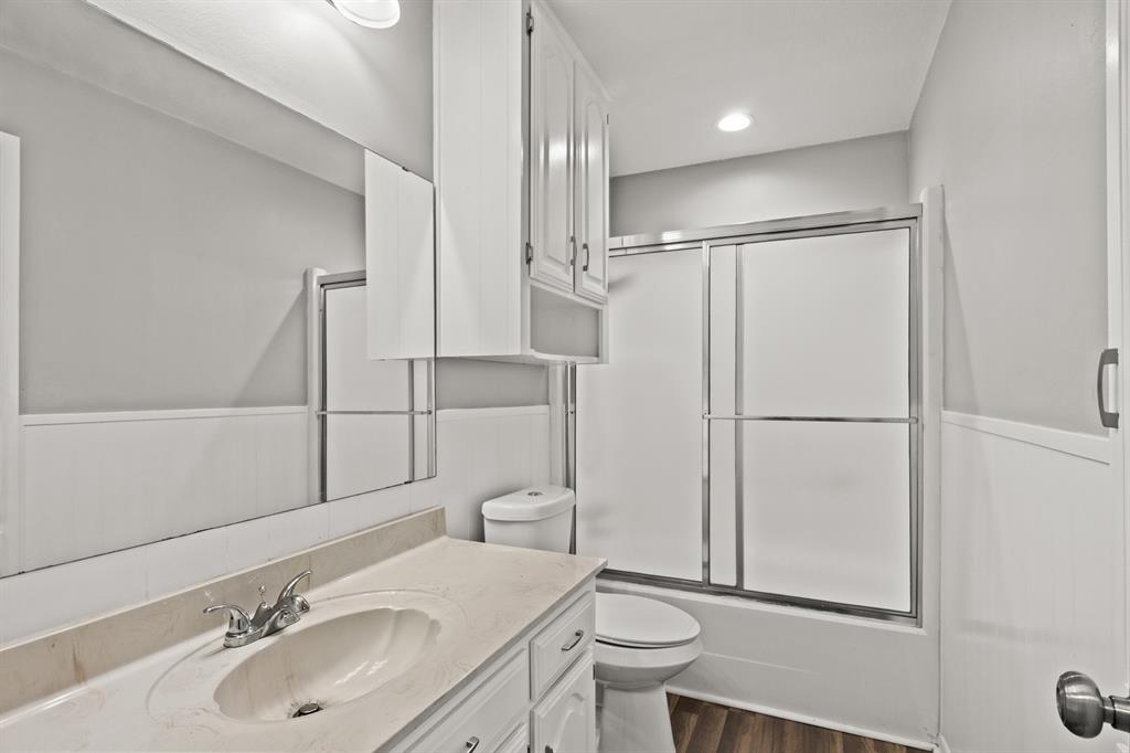 231 Quitman Street Pittsburg, TX 75686 - Photo 24 of 32 a bathroom with a sink toilet and shower