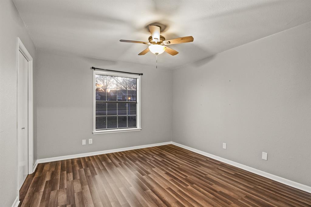 231 Quitman Street Pittsburg, TX 75686 - Photo 25 of 32 a view of empty room with wooden floor and fan