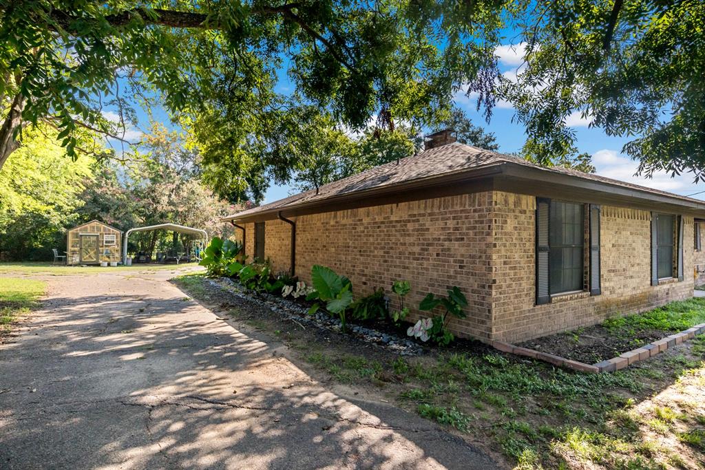 231 Quitman Street Pittsburg, TX 75686 - Photo 32 of 32 a view of a house with a yard