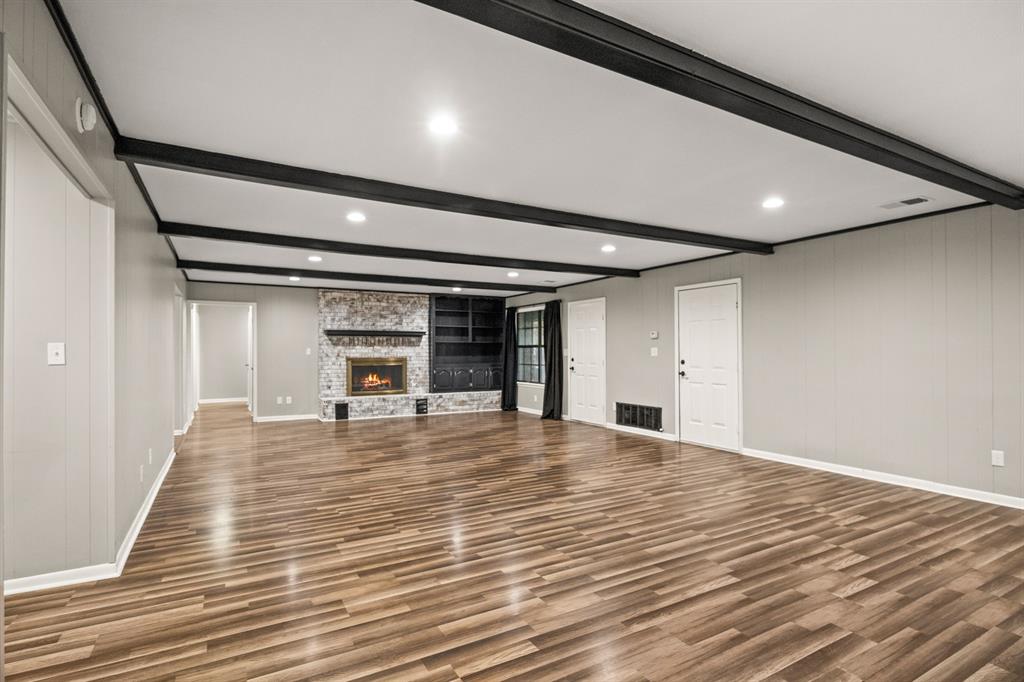 231 Quitman Street Pittsburg, TX 75686 - Photo 8 of 32 a view of a room with wooden floor and a window