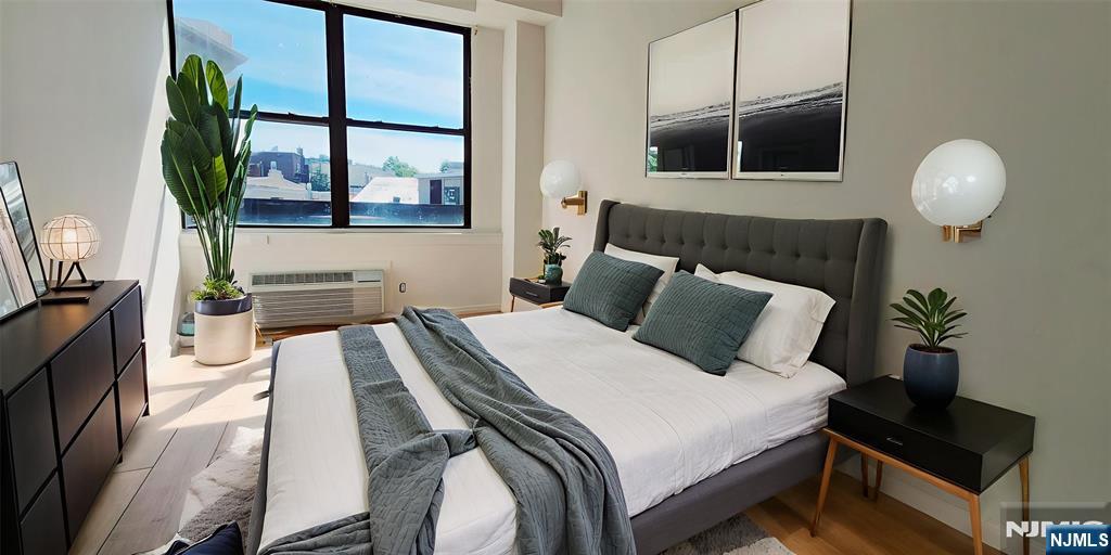 30 Howe Avenue, Unit 301 Passaic, NJ 07055 - Photo 8 of 10 a spacious bedroom with a bed and window