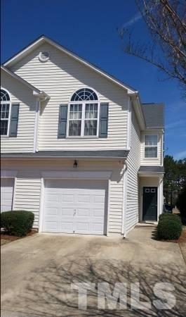 2116 Persimmon Ridge Drive Raleigh, NC 27604 - Photo 1 of 5 a front view of a house with a yard and garage