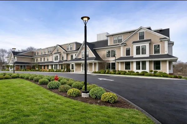 a front view of a house with a garden and plants