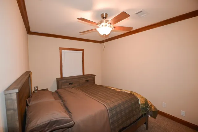 a bedroom with a bed and a chandelier