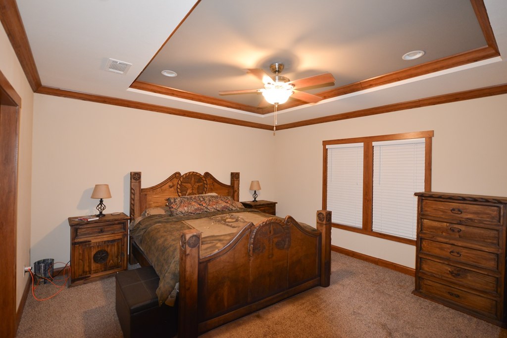 Undisclosed Address Rocksprings, TX 78880 - Photo 15 of 34 a bedroom with a bed and a chandelier