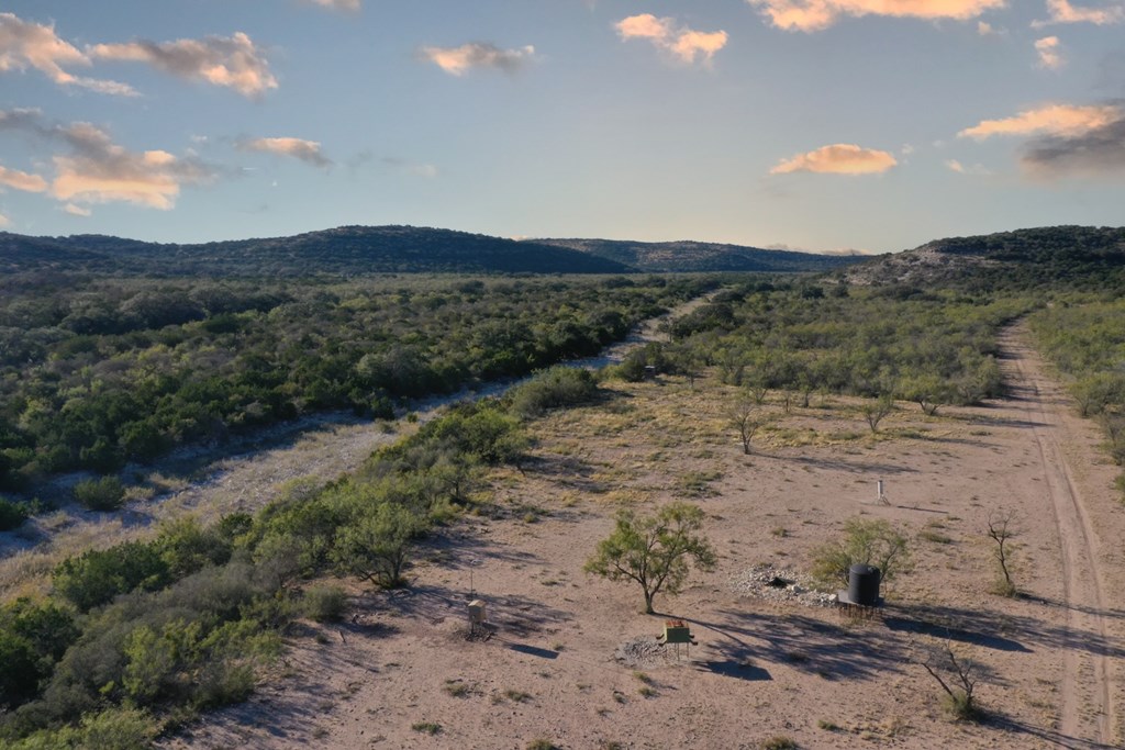 Undisclosed Address Rocksprings, TX 78880 - Photo 4 of 34 a view of a dry yard with mountains in the background