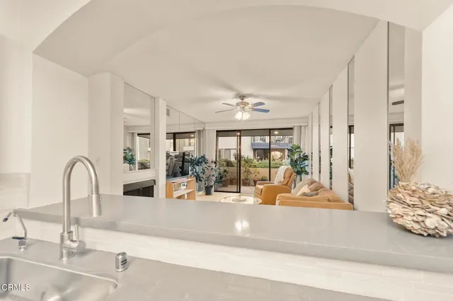 a kitchen with a sink and a refrigerator with a sink