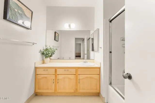a spacious bathroom with a sink and a large mirror