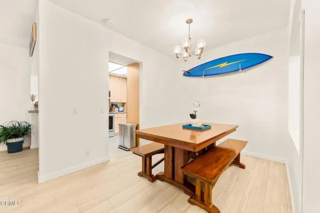 a view of a dining room with furniture and a chandelier
