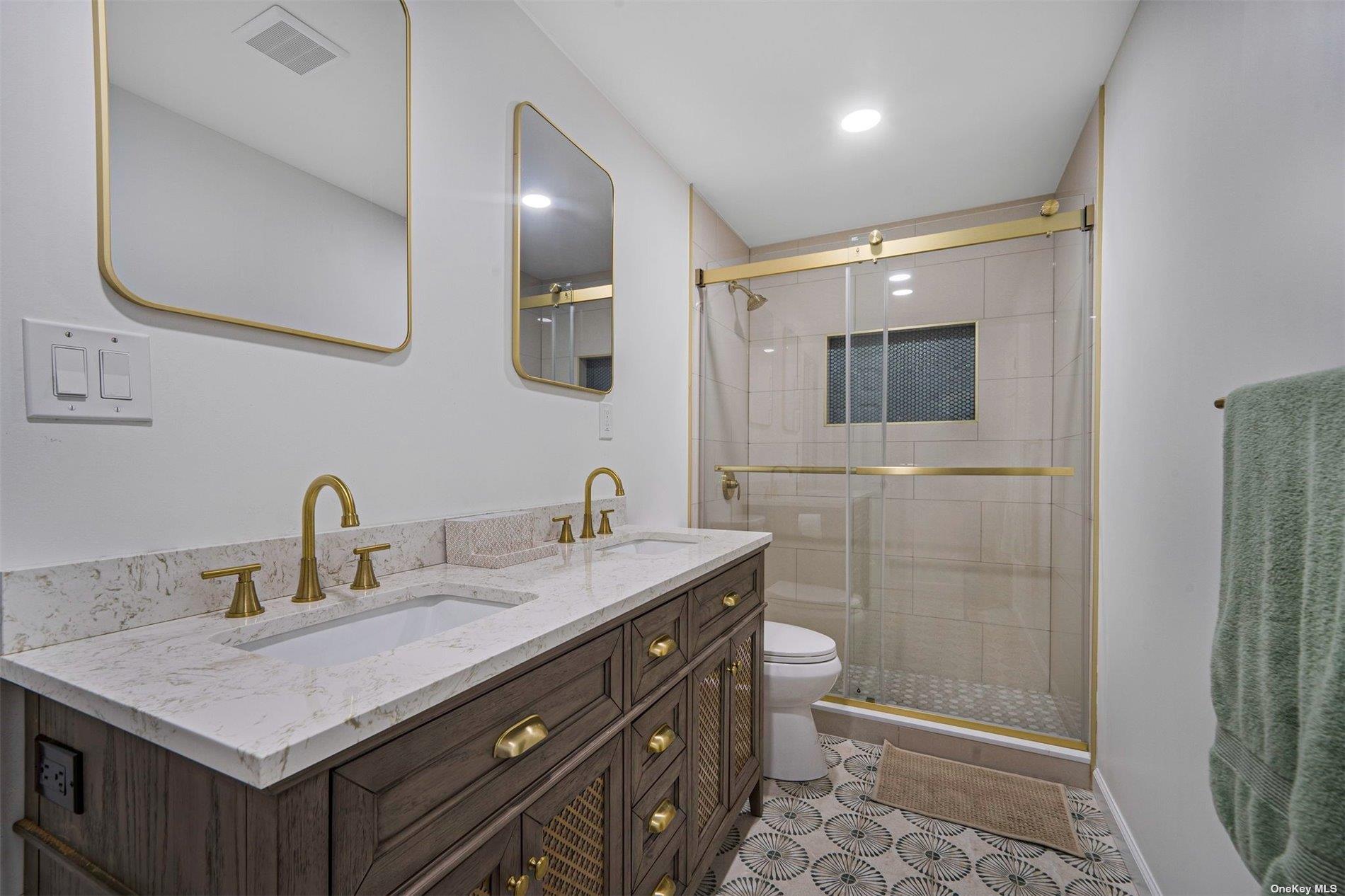 6 Rolling Hill Road Hampton Bays, NY 11946 - Photo 12 of 28 a bathroom with a sink a toilet and shower