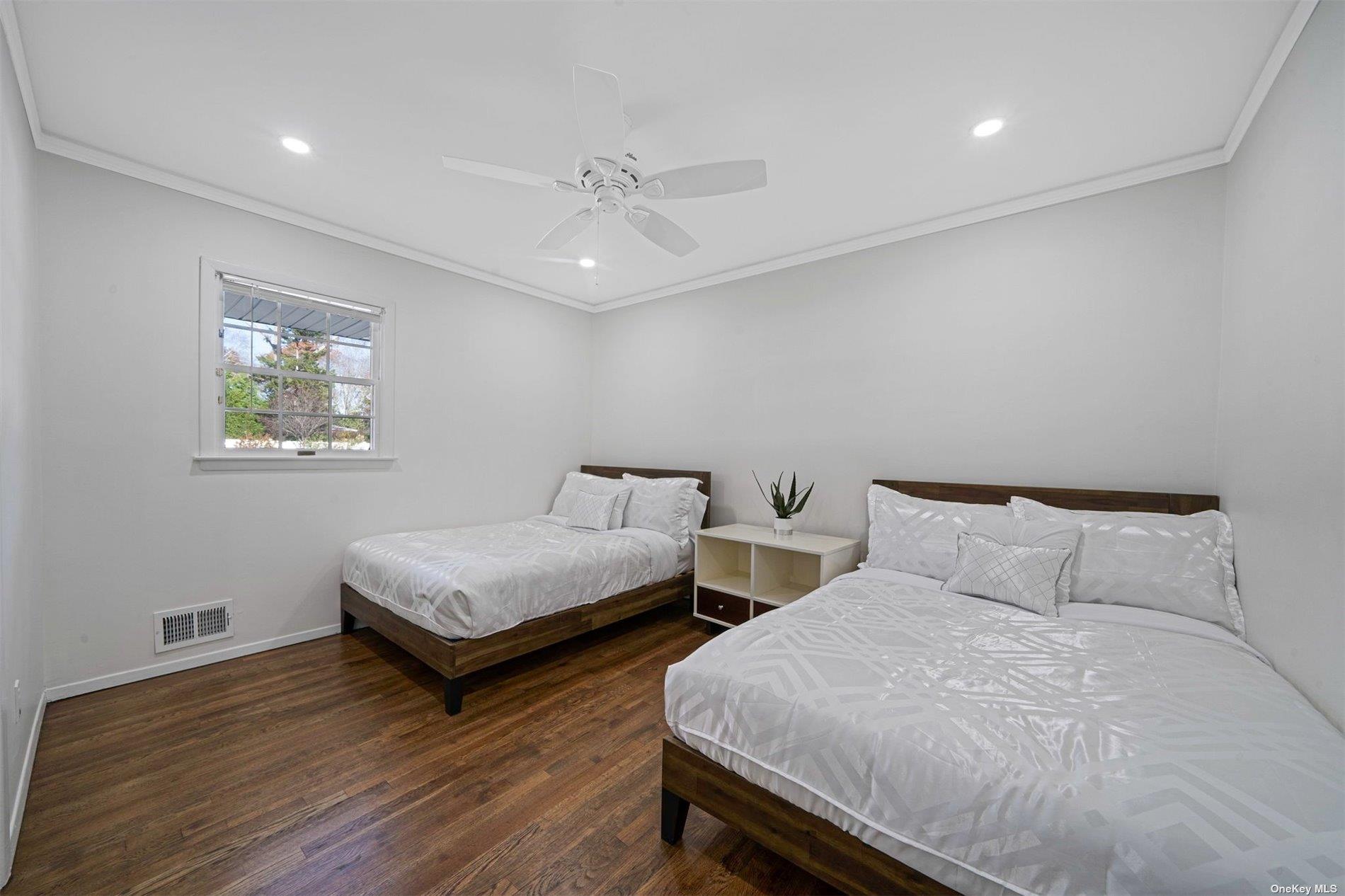 6 Rolling Hill Road Hampton Bays, NY 11946 - Photo 16 of 28 a bedroom with two beds and a desk