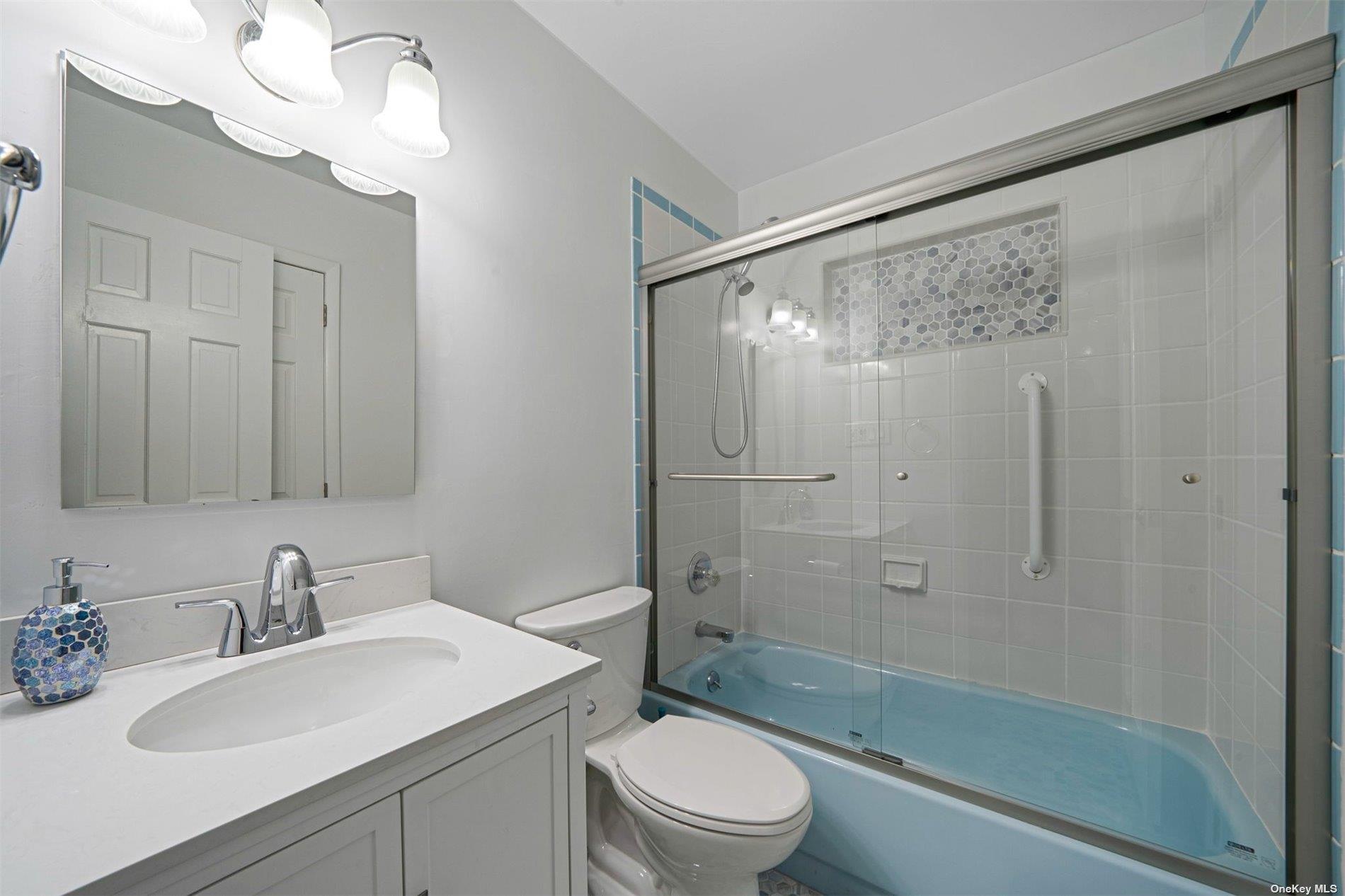 6 Rolling Hill Road Hampton Bays, NY 11946 - Photo 18 of 28 a bathroom with a sink a toilet and shower