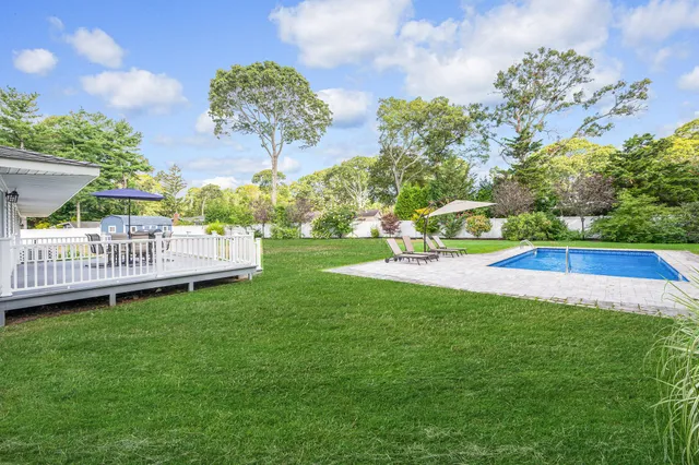 a view of a garden with a house in the background