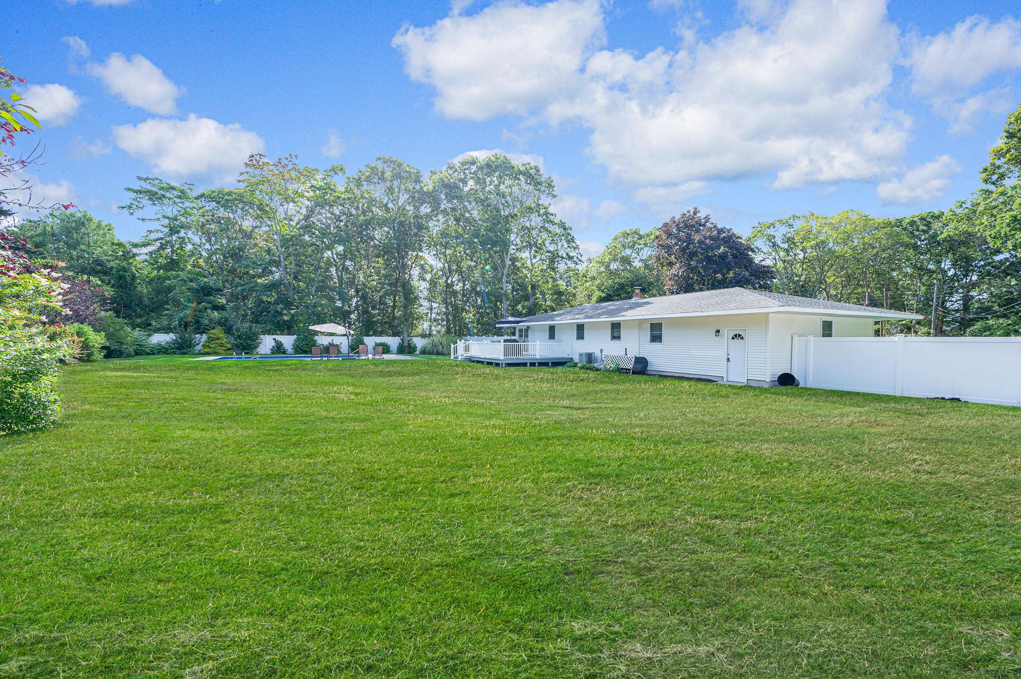 6 Rolling Hill Road Hampton Bays, NY 11946 - Photo 25 of 28 a view of an house with backyard space and garden