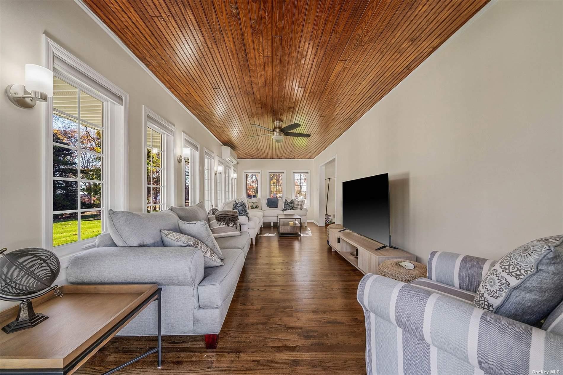 6 Rolling Hill Road Hampton Bays, NY 11946 - Photo 6 of 28 a living room with furniture and a flat screen tv