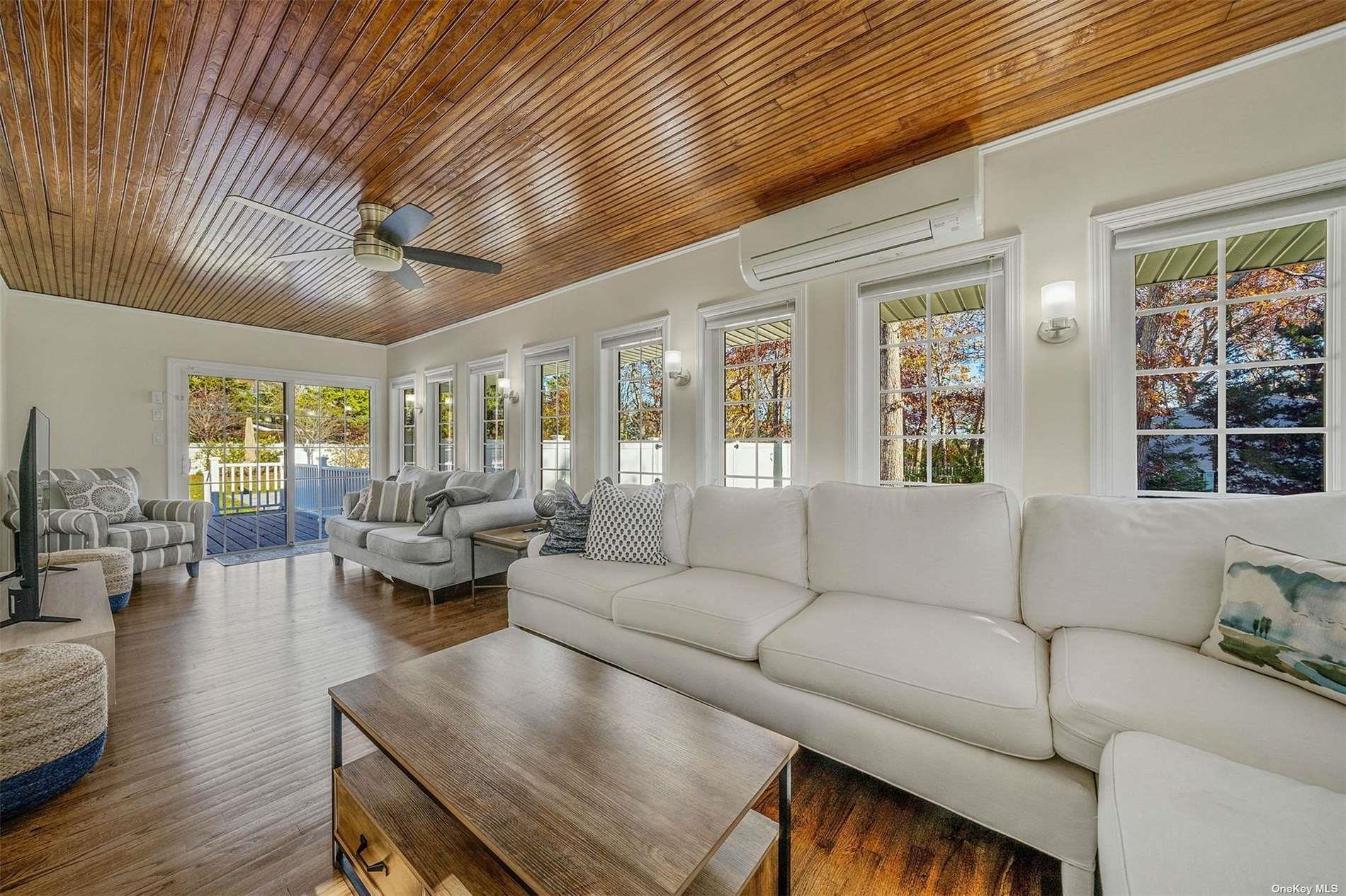 6 Rolling Hill Road Hampton Bays, NY 11946 - Photo 7 of 28 a living room with furniture and a large window