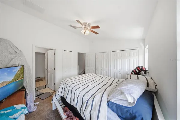 a bedroom with a bed and a chandelier