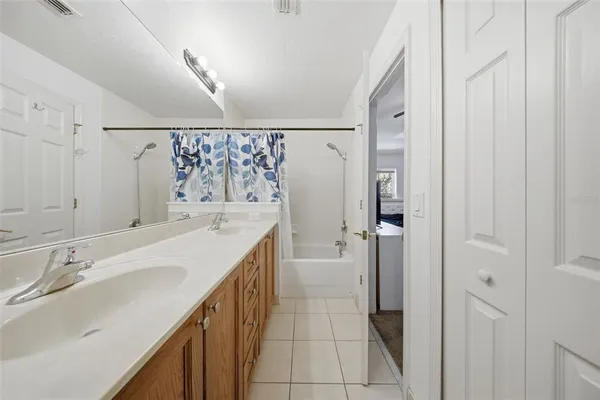 a bathroom with a sink a mirror and a shower
