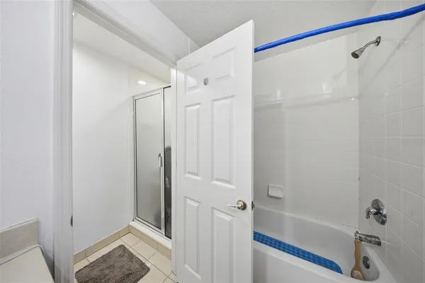 a bathroom with a shower and a tub