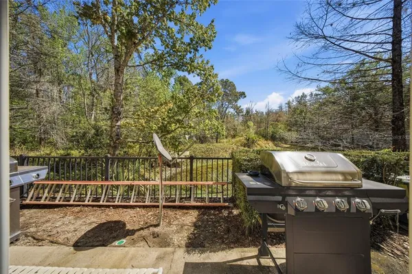 a view of a balcony with a yard
