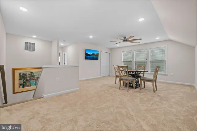 a view of a dining room with furniture and a window
