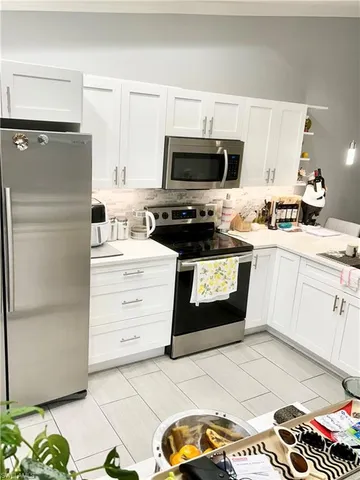 a kitchen with a appliances and cabinets