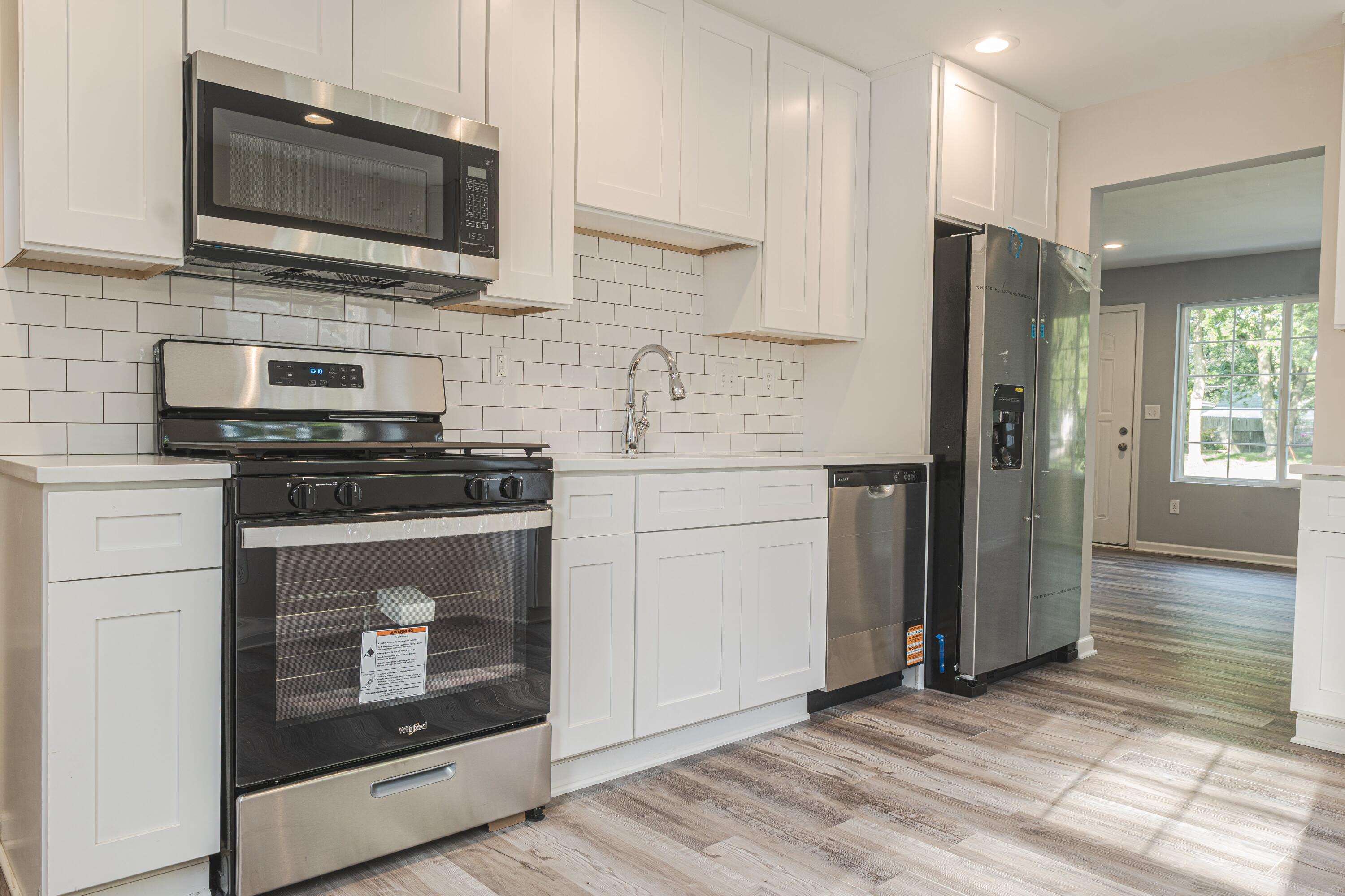 719 Imperial Road Valparaiso, IN 46385 - Photo 3 of 12 a kitchen with stainless steel appliances a stove microwave and refrigerator