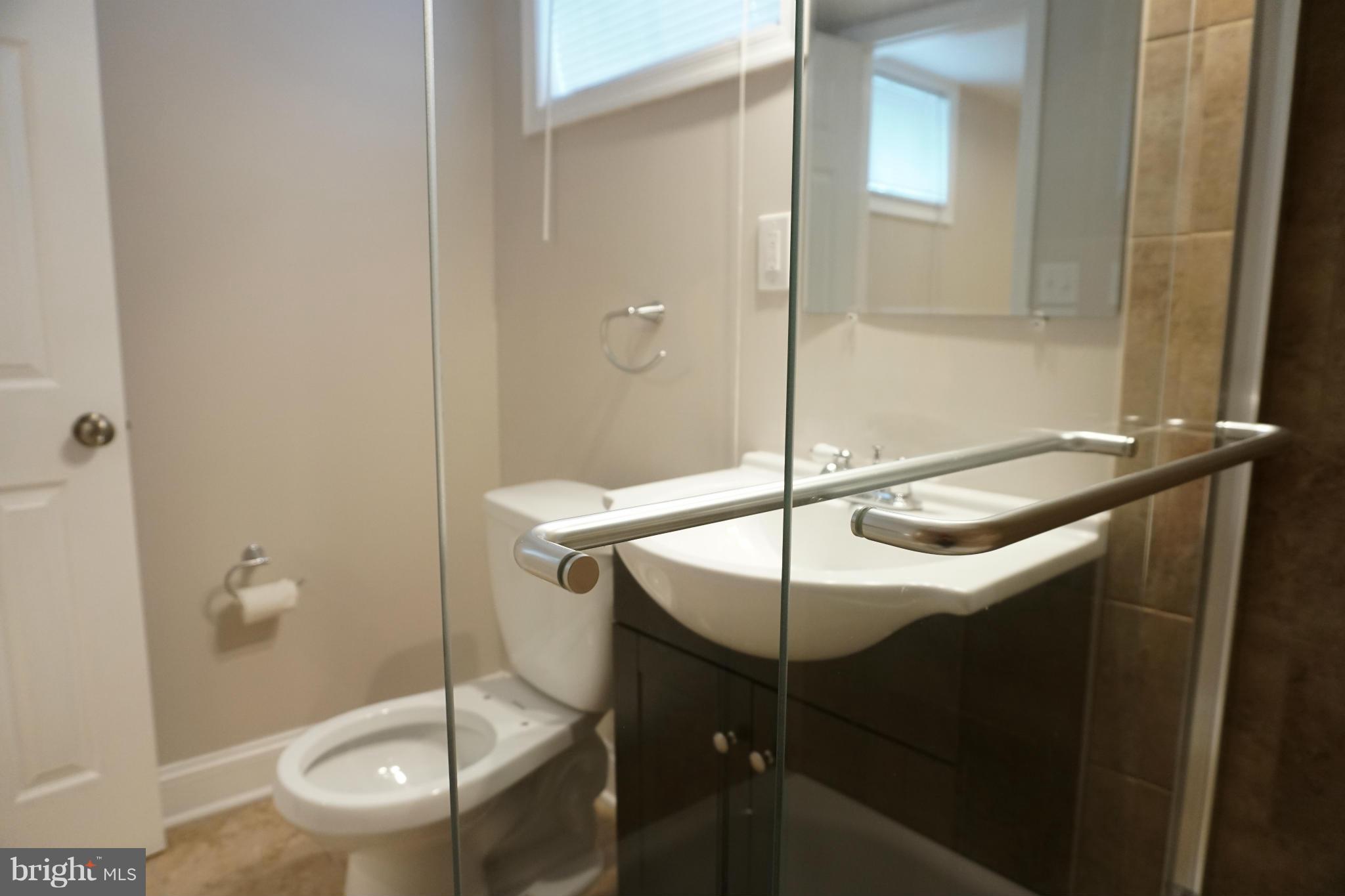 901 Wicklow Road Baltimore, MD 21229 - Photo 13 of 29 a bathroom with a sink a toilet and shower